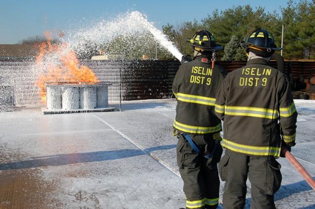 FF Madison and Probationary Firefighter McGhee operate the foam line at the flammable liquid live burn at Middlesex County Fire Academy on November 22, 2009.